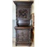 A Victorian carved dark oak cabinet, the front sec
