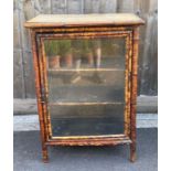 A 20th century tortoiseshell bamboo display cabine