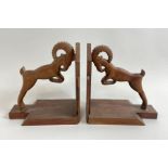 Two mid century wooden book ends, each with a char