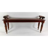 A 19th century mahogany window bench, with scroll