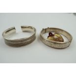 A half engraved silver hinged bangle, and a patter