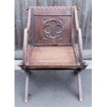 An early 20th century oak Glastonbury chair, with