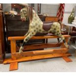 A 20th century painted rocking horse, standing on