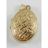 A 9ct gold oval locket, the front with embossed de