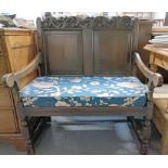 A 19th century oak two seater bench, with carved a