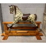 A 20th century painted rocking horse, standing on
