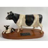 A Beswick model of Friesian cow and calf, standing