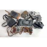 A collection of vintage cameras including Lumiere