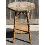 A 20th century bamboo table, standing on four spla