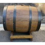 A 20th century oak spirit/drinks barrel, on oak st