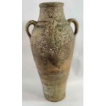 A weathered terracotta amphora or olive oil jar wi