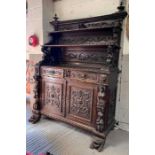 A Victorian dark oak sideboard/buffett, heavily ca
