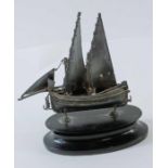 A small model of a sail boat, possibly Maltese, on