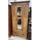 An early 20th century pine single wardrobe, with a