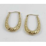 A pair of embossed hoop earrings, stamped ‘375’; 1