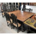 A Victorian dark oak table and chairs, each carved
