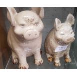 2 glazed stoneware seated pigs