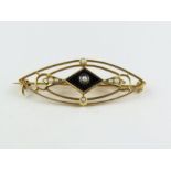 A black onyx and seed pearl brooch, stamped ’14k’,