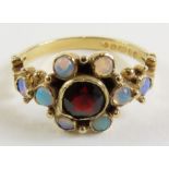 A 9 carat gold opal and garnet dress ring, finger