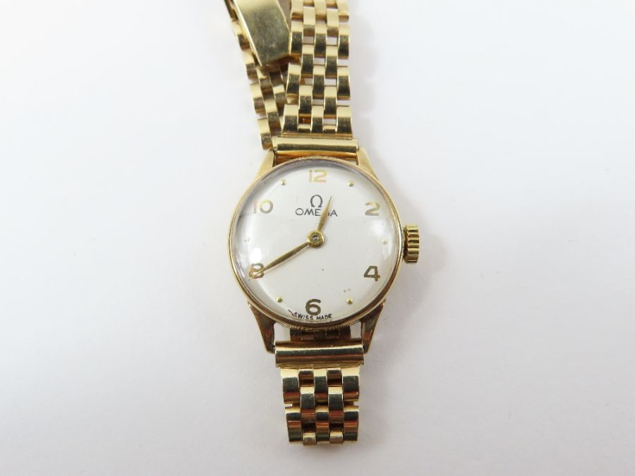 Omega, a ladies 9ct gold wrist watch, the round wh