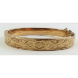 An unmarked gold hinged bangle,