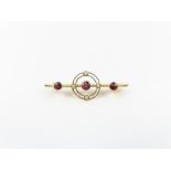 A 9 carat gold garnet and seed pearl bar brooch, C