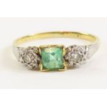 A three stone emerald and diamond ring, stamped ‘1