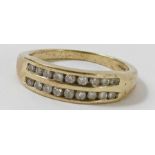 A 9 carat gold eighteen stone diamond half hoop ri