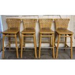 A set of four McGuire company stools