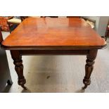 A 20th century mahogany wind out table, with addit