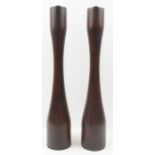 A pair of mid century teak candlesticks, 23cm high