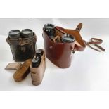 Three pairs of binoculars, all in leather cases, m