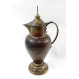 An early 20th century religious copper lidded jug,