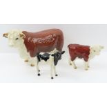 A Beswick Hereford bull, along with two calves
