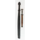 A tribal short sword, in a leather sheath, 34cm lo