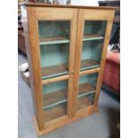 A Victorian pine two door glazed bookcase, 146cm h