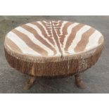 An African Zebra hide drum table, standing on thre