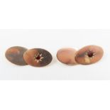 A pair of rose gold cufflinks, each oval marked '9