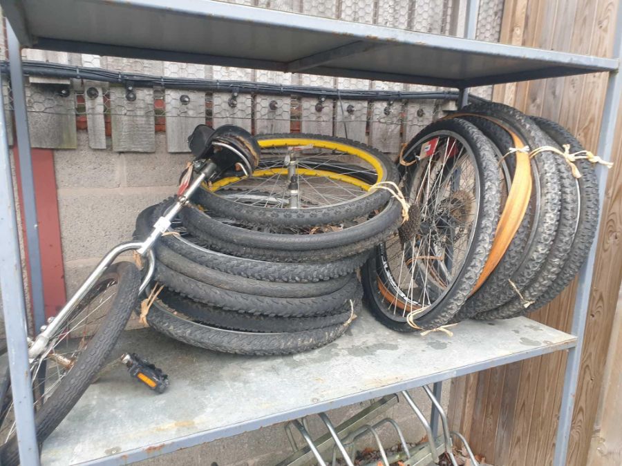 Five bundles of bicycle wheels with a unicycle