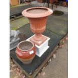 Terracotta garden urn on base along with stoneware