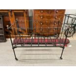 A 20th century childrens iron bed, 95cm high, 123cm l