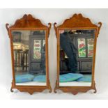 A pair of 18th century style shaped wall mirrors,