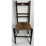An early 20th century oak single chair, with rush