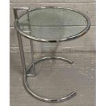 A 20th century chrome and glass adjustable table,
