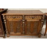 A 20th century carved oak sideboard, with three ca
