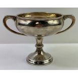 A silver two handled cup on tapered foot with stem