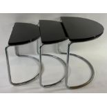A nest of three glass and chrome half moon tables,