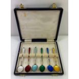 A cased set of enamelled and gilded coffee spoons,