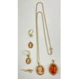 A 9ct gold amber pendant, a 9ct gold cameo pendant