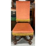 A 20th century high backed chair, standing on hard